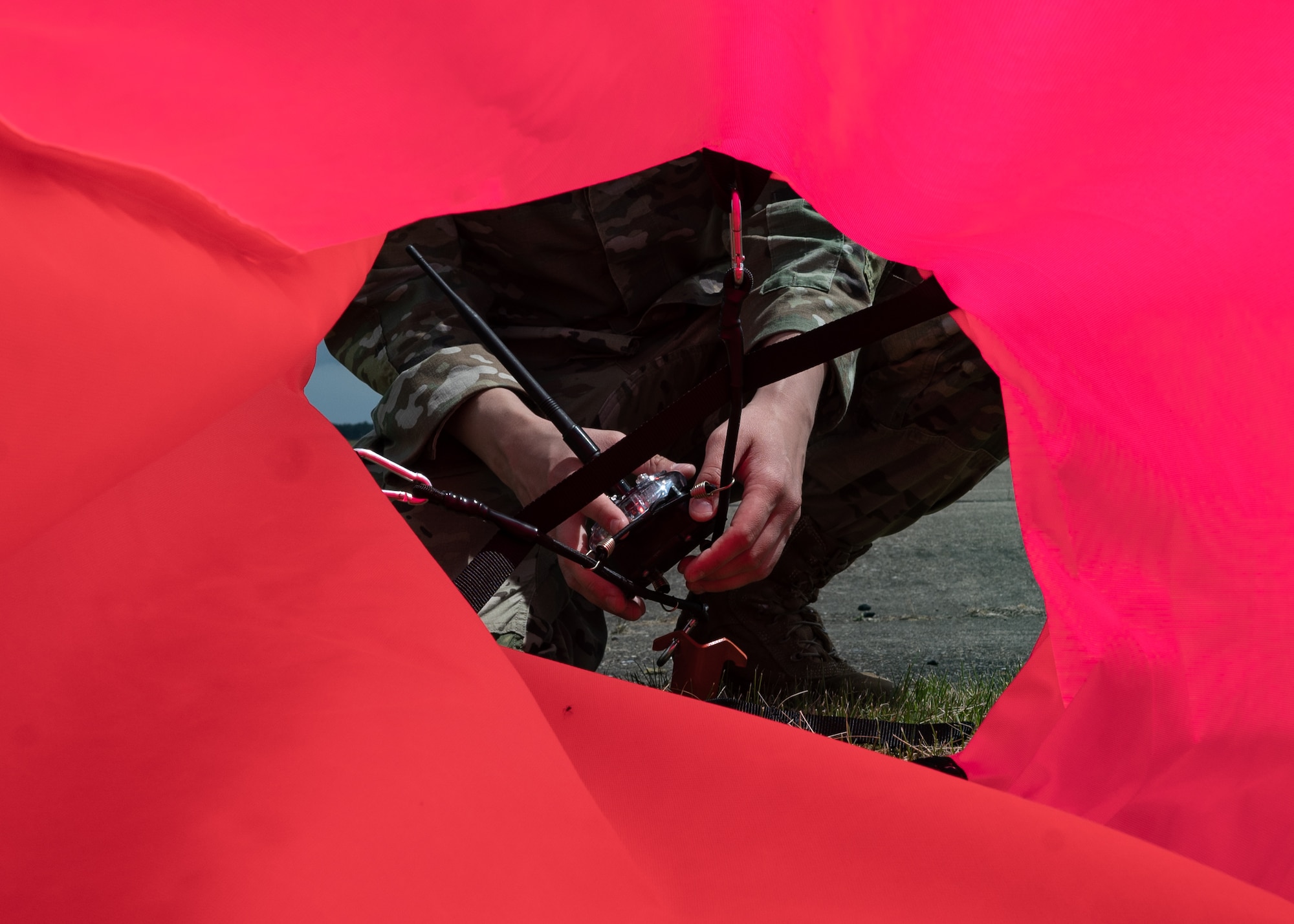 U.S. Air Force member setting up a landing zone marker panel.