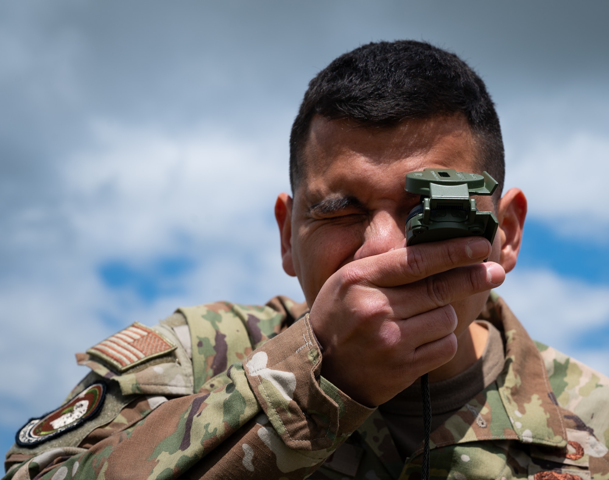 U.S. Air Force member checking headings with a compass.