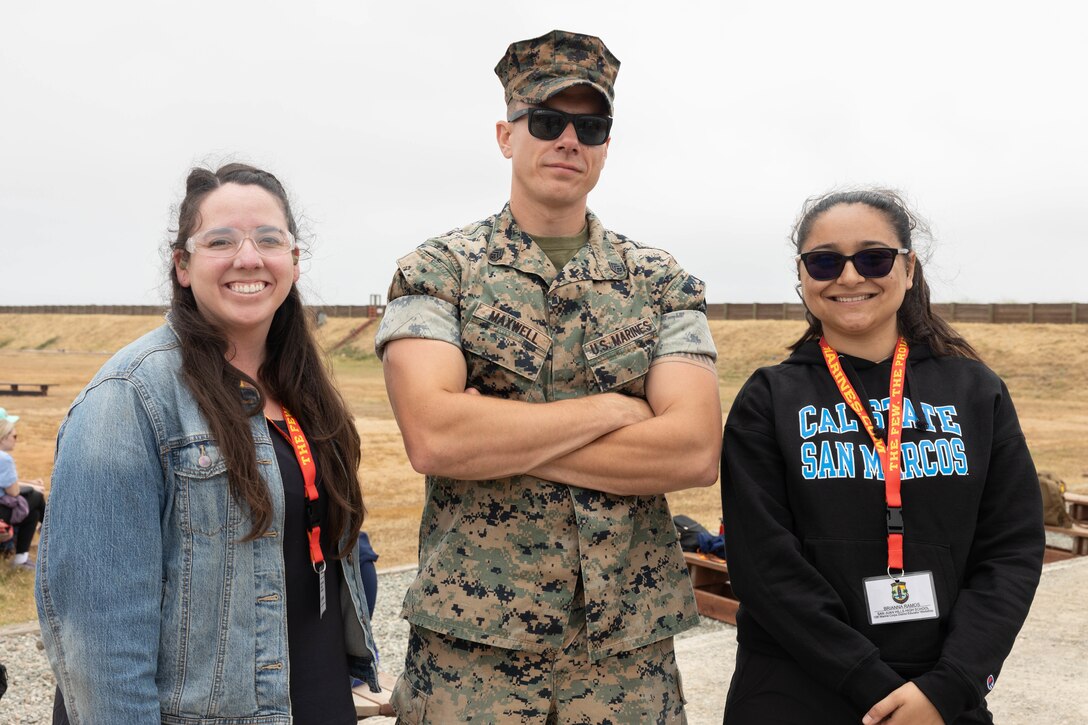 Kelly Waugh, an educator with Capistrano Valley High School, left, U.S. Marine Corps Staff Sgt. Lee Maxwell, a canvassing recruiter with Recruiting Sub-Station Mission Viejo, Recruiting Station Orange County, middle, and Briana Ramos, an educator with San Juan Hills High School, pose for a photograph during an Educators Workshop event at Marine Corps Base Camp Pendleton in Oceanside, Calif., June 5, 2024. The Educators Workshop program provides selected educators and influential community members with an experiential opportunity to see how the Marine Corps transforms young men and women into Marines. The workshop also provides attendees with current information regarding Marine Corps training practices, military job skills, service opportunities, military lifestyle, and educational benefits available to Marines. (U.S. Marine Corps Cpl. Fred Garcia)