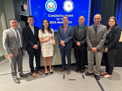 IMAGE: Pictured with Naval Surface Warfare Center Dahlgren Division Technical Director, Dale Sisson Jr., P.E., SES and Integrated Engagement Systems Department Head Shellie Clift are Dr. Udayan Bhapkar, Lindsey Klunder, James Latourell and William "Jack" Smith members of the Aurora Software Foundry Joint Laser Deconfliction Safety Software Team and Cory Willoughby, member of the AN/SPY-6(V) 1 Radar Aegis Baseline 10 Test Team. Both teams were recognized as winners of the Assistant Secretary of the Navy for Research, Development and Acquisition Dr. Delores M. Etter Top Scientists and Engineers of the Year Award for 2024. The teams were honored during a ceremony at the Pentagon, June 12.