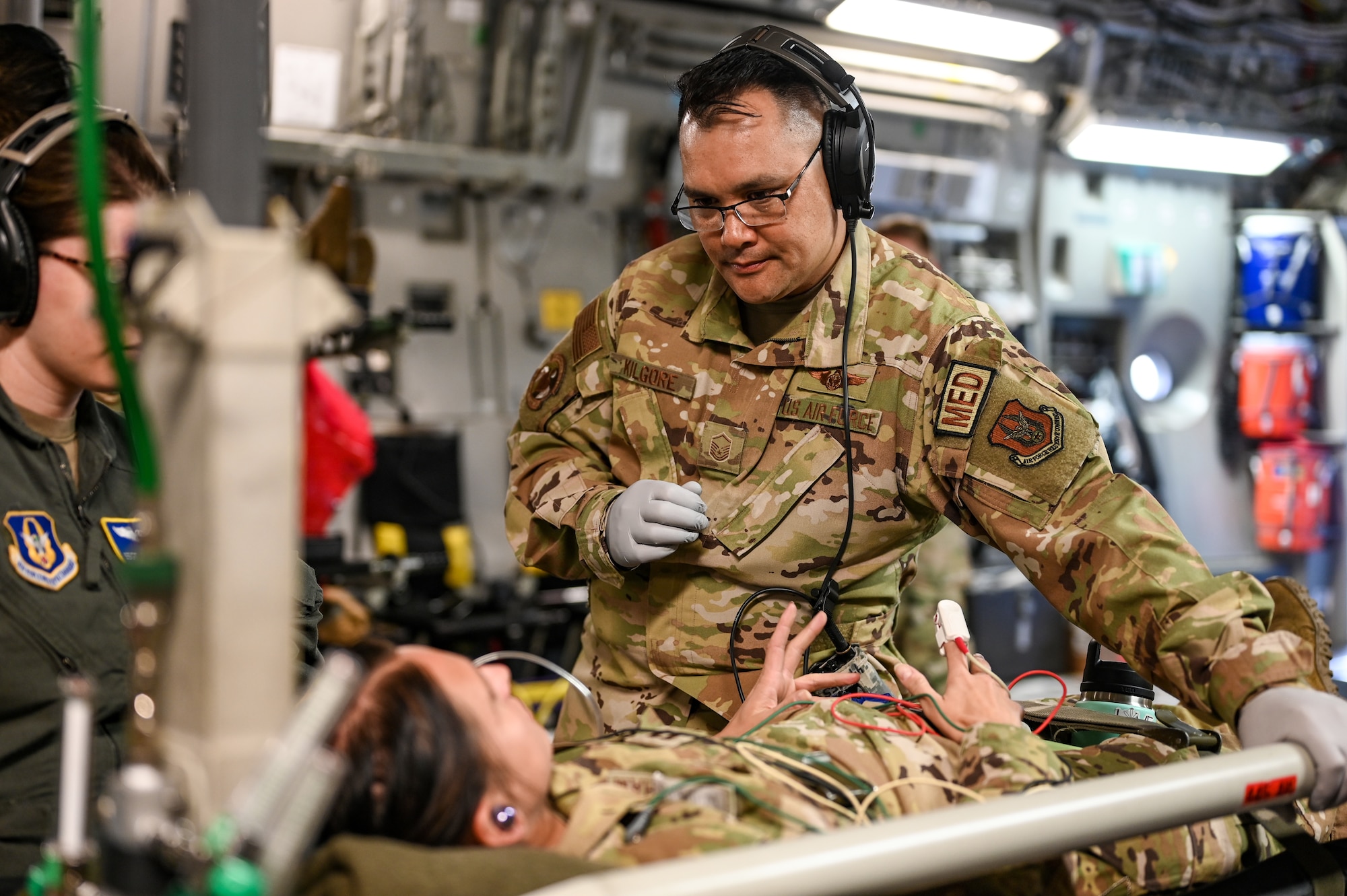 Master Sgt. Charles Kilgore, 445th Aeromedical Evacuation Squadron AE flight chief, checks on a “patient” onboard a C-17 Globemaster III during an AE training flight May 11, 2024. Twelve Citizen Reserve Airmen with the 445th Airlift Wing and 12 members with the 349th AES at Travis AFB, California, trained on a C-17 in several locations during their annual training May 8-13, 2024.