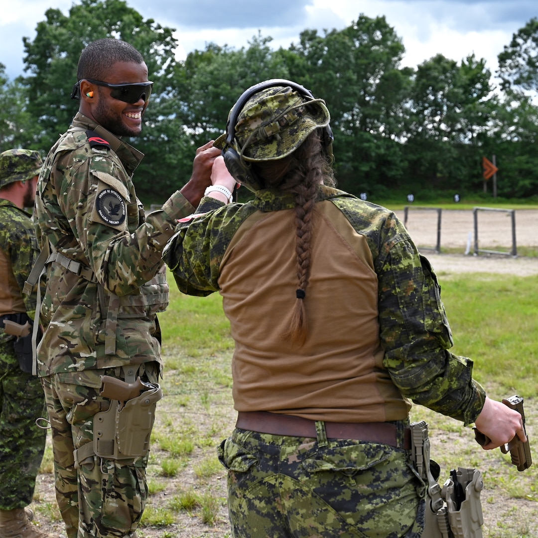 Cabo-Adjunto Ravidson Vezo Lopes of the Cabo Verdean Armed Forces and Master Cpl. Lisa Leopold of the Canadian Armed Forces fist bump after a pitsol match at the 2024 New Hampshire National Guard Combat Marksmanship Match on June 8 at Fort Devens, Mass. About 90 marksmen competed in the event, which featured various pistol and rifle courses of fire. Photo by Master Sgt. Charles Johnston, NHNG Deputy State PAO.