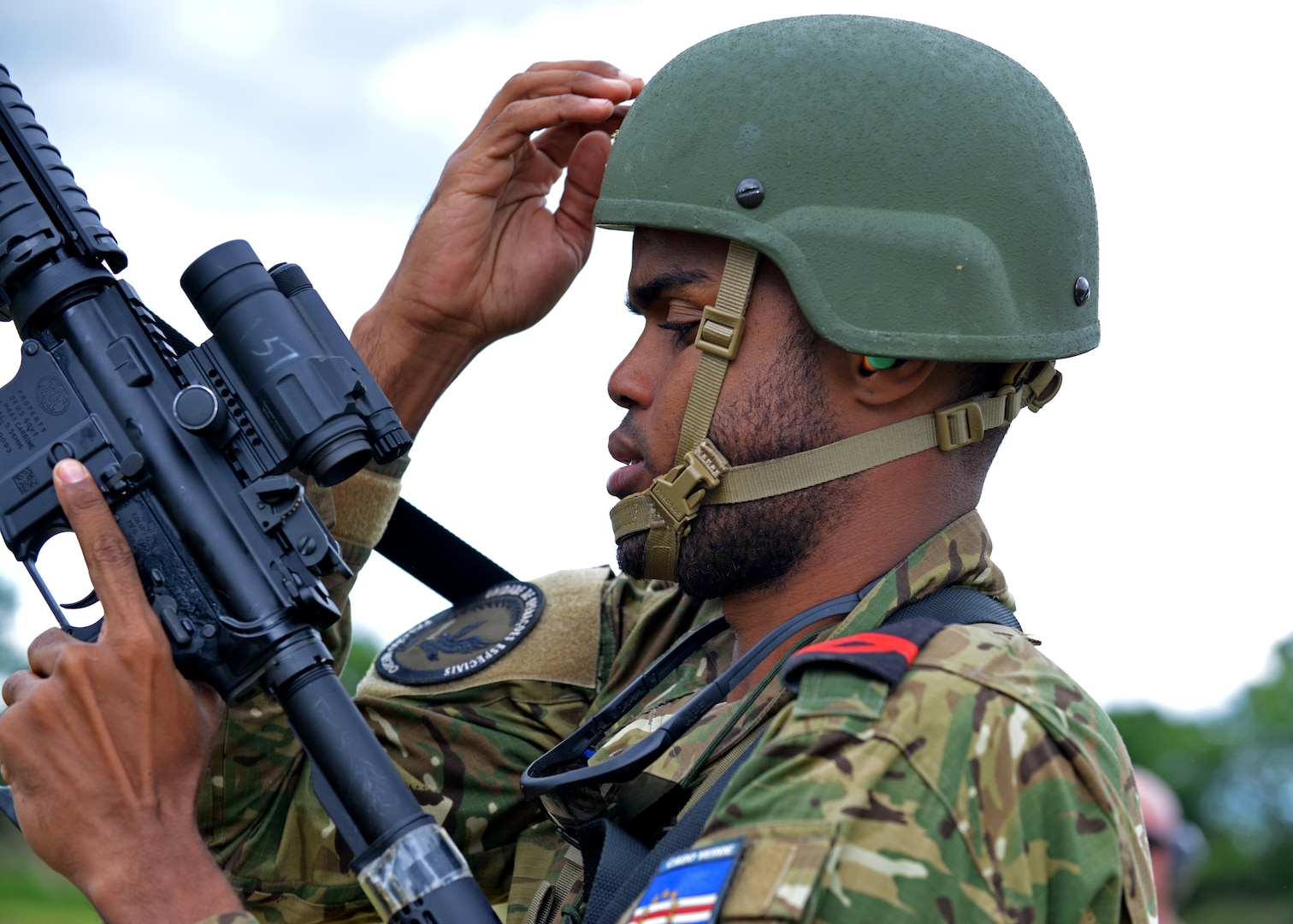 Cabo-Adjunto Ravidson Vezo Lopes of the Cabo Verdean Armed Forces and Master Cpl. Lisa Leopold of the Canadian Armed Forces fist bump after a pistol match at the 2024 New Hampshire National Guard Combat Marksmanship Match on June 8 at Fort Devens, Mass.