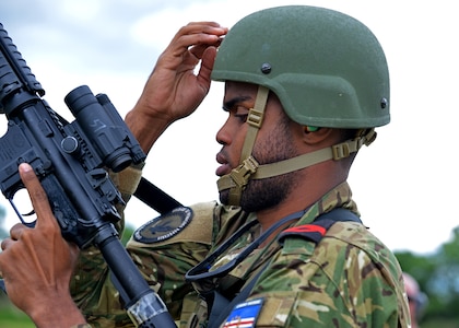 Cabo-Adjunto Ravidson Vezo Lopes of the Cabo Verdean Armed Forces and Master Cpl. Lisa Leopold of the Canadian Armed Forces fist bump after a pistol match at the 2024 New Hampshire National Guard Combat Marksmanship Match on June 8 at Fort Devens, Mass.