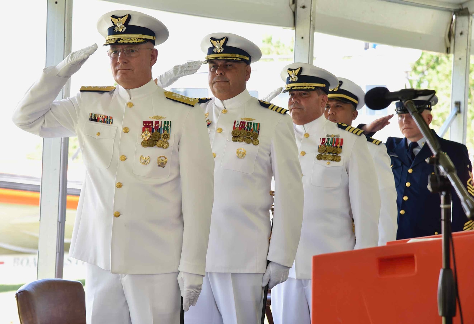 From front to rear, Rear Adm. Douglas M. Schofield, commander of the 7th Coast Guard District, Capt. José E. Díaz, Capt. Luis J. Rodríguez, LT. Genesis Guerrero, and Master Chief Petty Officer Michael Hvozda salute during the playing of anthems at the Sector San Juan Command Ceremony in San Juan, Puerto Rico June 13, 2024. During the ceremony, Capt. Luis J. Rodríguez relieved Capt. José E. Díaz as the commander of Sector San Juan. (Coast Guard Photo by Ricardo Castrodad)