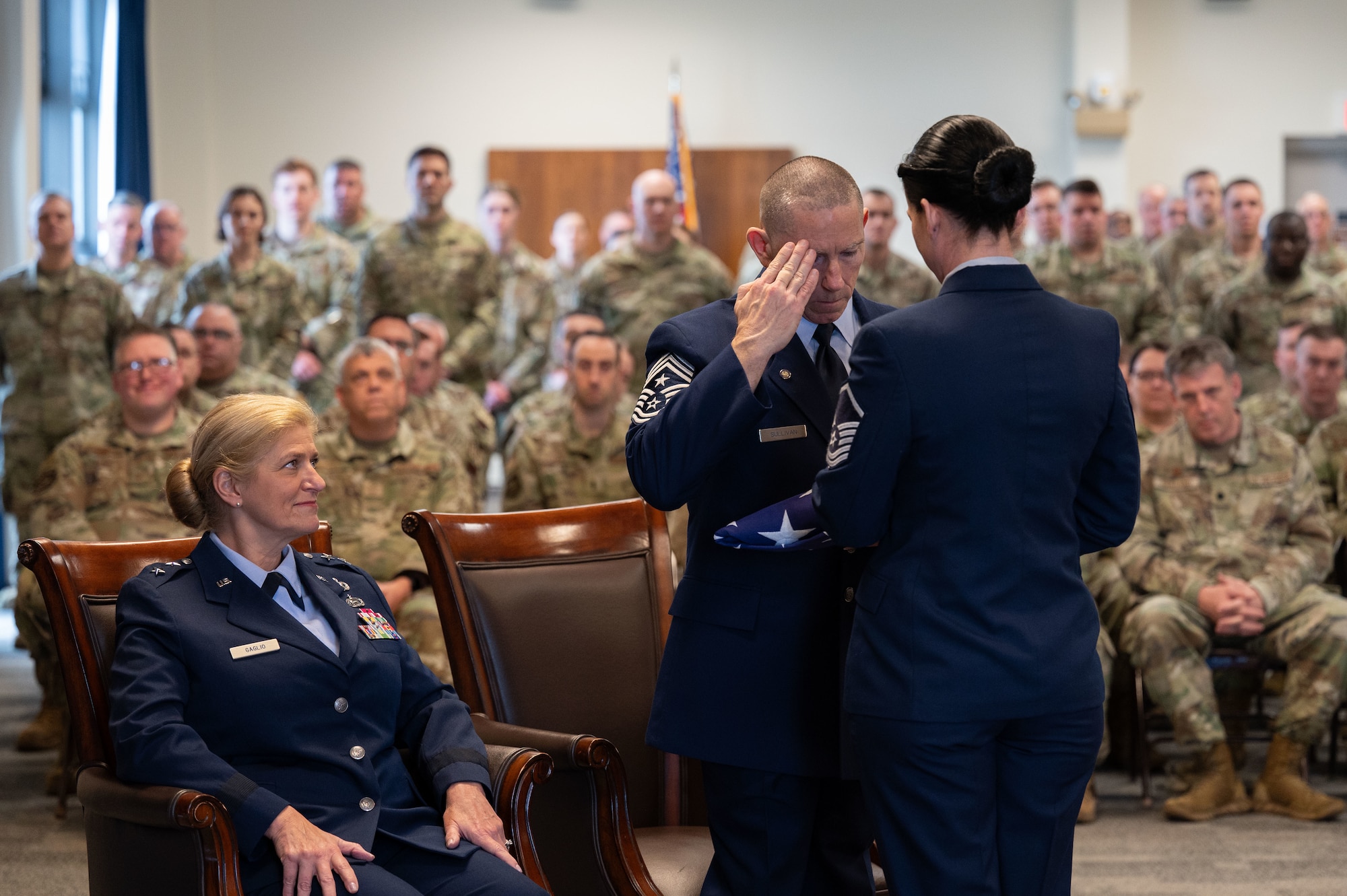 Chief Master Sgt. Sean Sullivan salutes the flag.