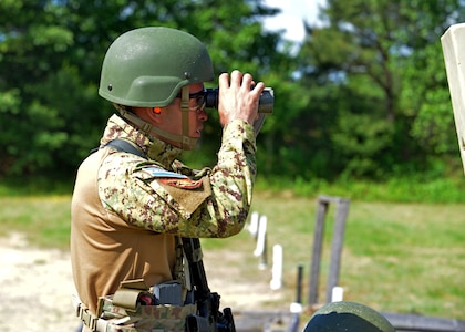 Stte. Inf. Jaime Eduardo Peraza Orantes spots targets downrange as his Team El Salvador teammates shoot the “Know Your Limits” rifle course at the 2024 New Hampshire National Guard Combat Marksmanship Match on June 8 at Fort Devens, Mass. His four-person team successfully defended its championship from last year, besting a field of 21 squads.