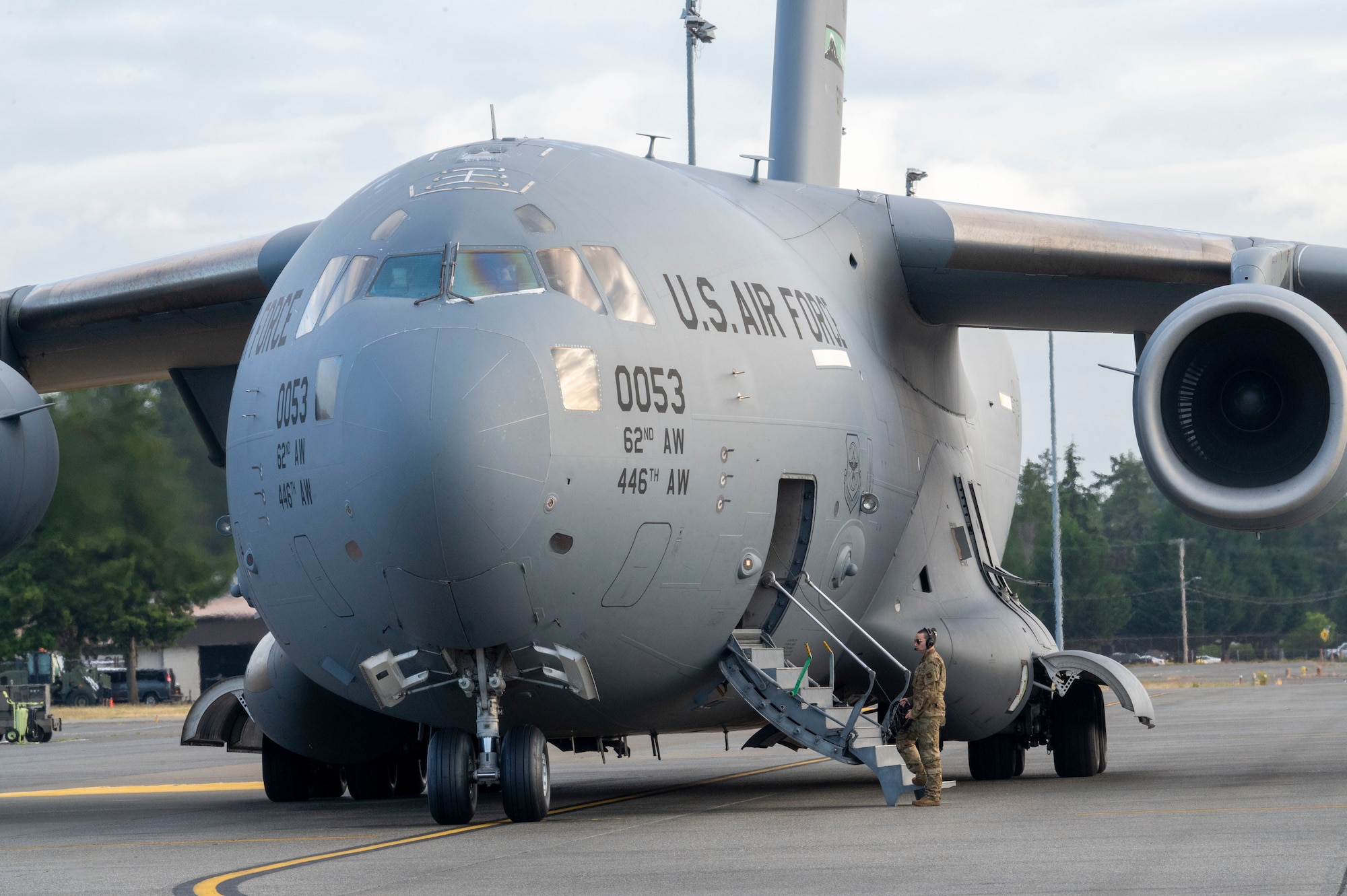 U.S. Air Force Airman 1st Class Wyatt Carlson, a loadmaster with the 4th Airlift Squadron, boards a C-17 Globemaster III during a contingency mission from Joint Base Lewis-McChord, Washington, June 12, 2024. Loadmasters are responsible for supervising the loading and unloading of cargo, vehicles and passengers on aircraft. (U.S. Air Force photo by Senior Airman Colleen Anthony)