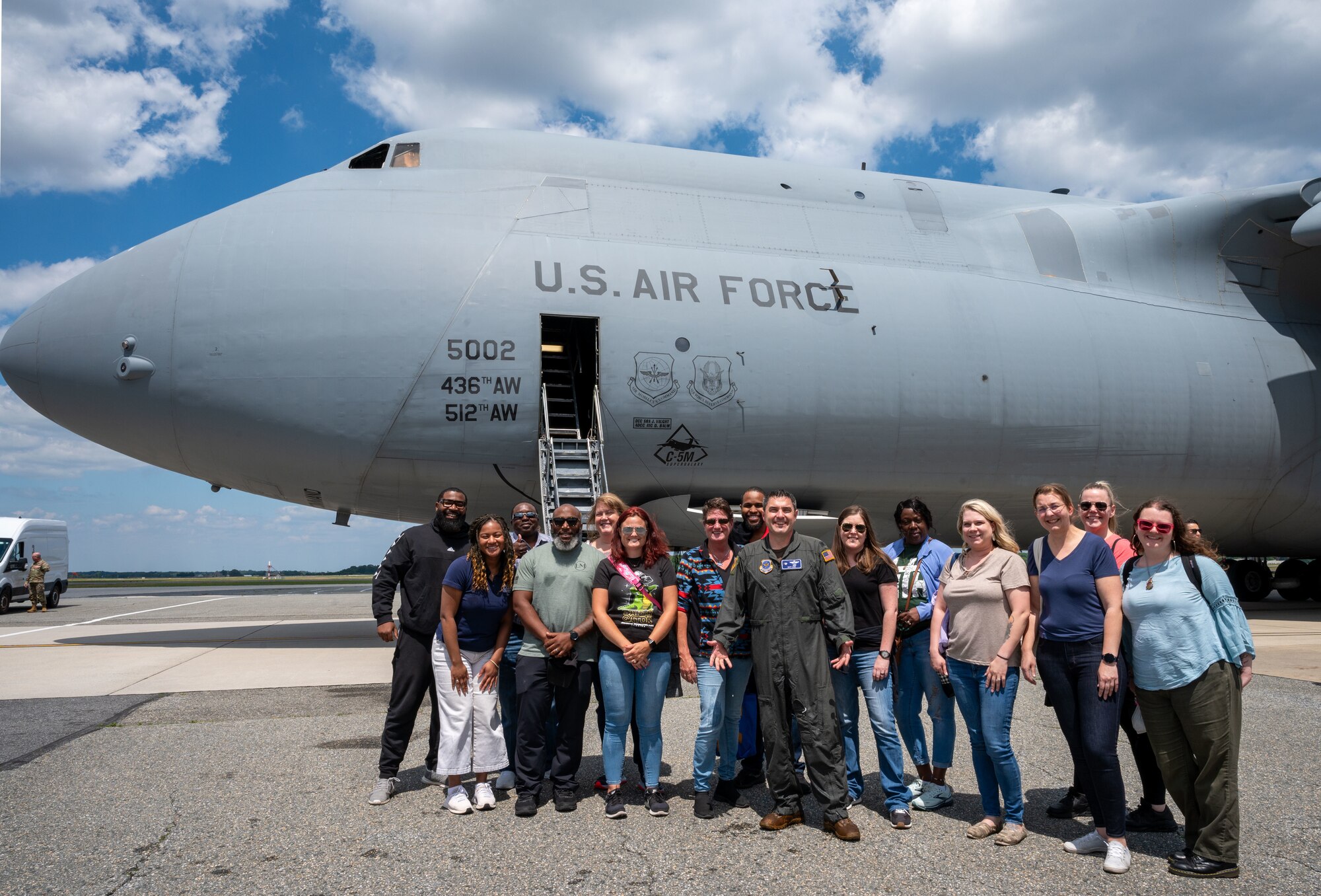 U.S. Air Force Col. Rusty Gohn, 436th Airlift Wing deputy commander and members of the Central Delaware Chamber of Commerce Leadership Central Delaware program pose for a photo in front of a C-5M Super Galaxy at Dover Air Force Base, Delaware, June 12, 2024. The LCD members flew with the 9th Airlift Squadron as part of a community engagement opportunity to learn how Dover AFB stays prepared to deliver rapid global mobility. (U.S. Air Force photo by Senior Airman Amanda Jett)