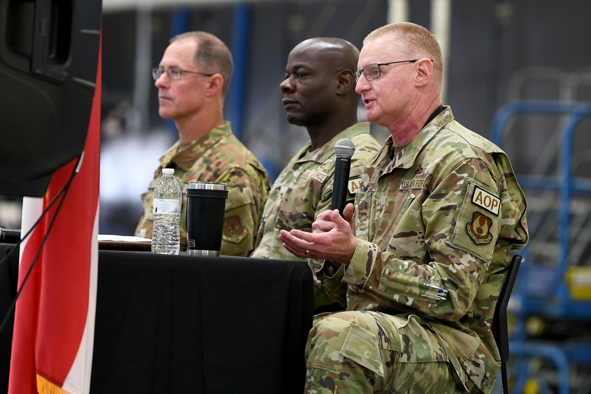 Three men in military uniform sitting at a table