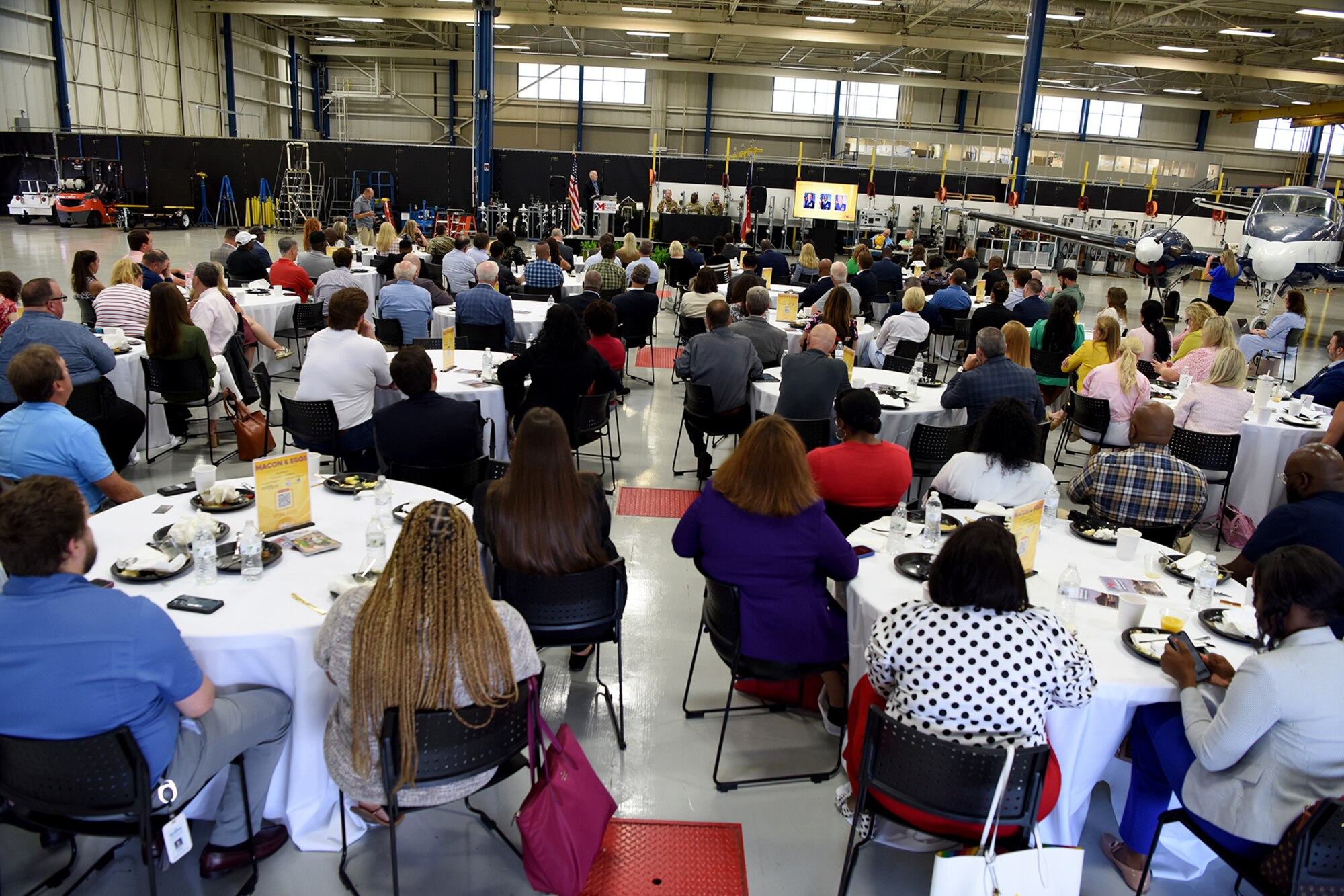 A large group of people sitting at tables