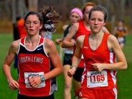 Christina O'Brian (L) and Victoria Rollin run in a cross-country competition.