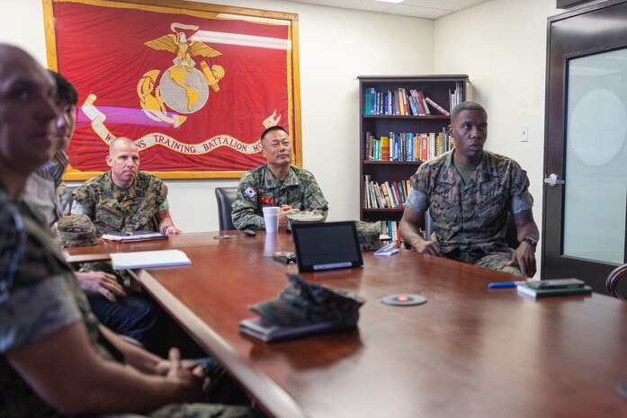 Sgt. Maj. Sang Gyun Yoon, the Republic of Korea Sergeant Major of the Marine Corps, center right, U.S. Marine Corps Sgt. Maj. Hector Soto-Rodriguez, the Sergeant Major of U.S. Marine Corps Forces Korea, center left, and Marines with Weapons Field Training Battalion, Recruit Training Regiment, receive a brief on the procedures recruits go through while at Marine Corps Base Camp Pendleton, California, May 28, 2024. Sgt. Maj. Sang Gyun Yoon visited the recruit depot to gain a deeper understanding of U.S. Marine Corps training methods and to explore how these techniques could be integrated into their own Marine Corps training programs. (U.S. Marine Corps photo by Lance Cpl. Jacob B. Hutchinson)