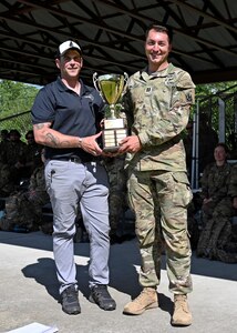 Sgt. 1st Class Joe Wyner, state marksmanship coordinator, New Hampshire Army National Guard, left, presents Capt. Robert Matzelle, commander of Charlie Company, 3rd Battalion, 172nd Infantry Regiment (Mountain), with the first-place trophy as the 2024 New Hampshire National Guard Combat Marksmanship Match individual champion June 8, 2024. Matzelle defended his title from last year as the match’s top shot, placing first out of 90 competitors.