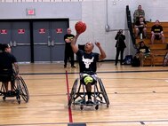 Retired Staff Sgt. Gene Calantoc steals the ball and makes the basket in a wheelchair basketball competition at the 2024 Army Trials