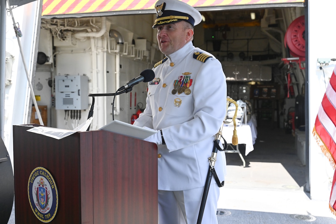 Capt. Matthew Hammond reads his official transfer orders as commanding officer of U.S. Coast Guard Cutter Calhoun (WMSL 759) during a change-of-command ceremony, June 11, 2024, in North Charleston, South Carolina. The change-of-command ceremony is a time-honored military tradition that marks a transfer of total authority and responsibility from one individual to another. (U.S. Coast Guard photo by Petty Officer 3rd Class Amber Mcgruder)