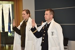 Newly minted Interservice Physician Assistant Program (IPAP) graduates U.S. Army Capt. Maria Bienhoff and 1st Lt. Joseph Love of the Pennsylvania Army National Guard take the oath of office on June 7, 2024 inside United Services Organization building located in Bethesda, MD.