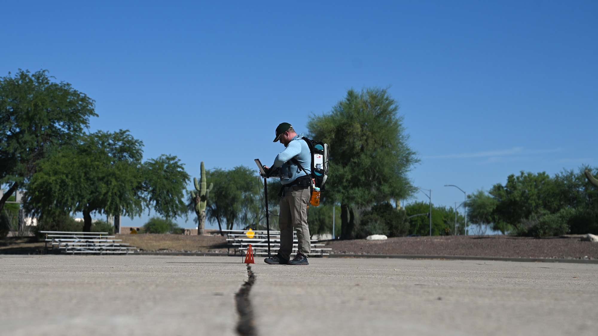 Derek Ensign, U.S. Geological Survey physical scientist, conducts hyperspectral imaging at Davis-Monthan Air Force Base, Ariz., June 11, 2024. The USGS field team gathered data to increase the nation’s geologic knowledge of critical mineral resources. (U.S. Air Force photo by Tech. Sgt. Sergio A. Gamboa)