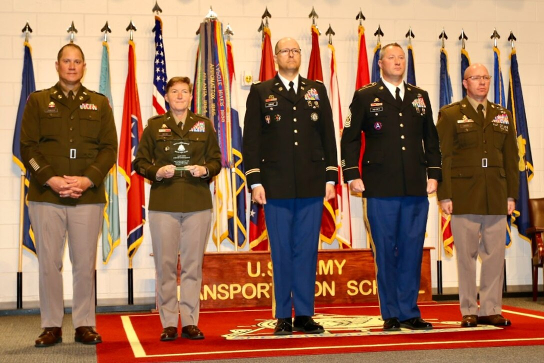 Brig. Gen. Beth A. Behn, second from left, the U.S. Army’s chief of transportation, presents the U.S. Army Transportation Corps’ Reserve Component Large Unit of the Year award for 2023 to Lt. Col. Michael Siriani, center, commander, 228th Transportation Battalion, at the U. S. Army Transportation Corps' annual awards ceremony May 6 at Fort Gregg-Adams, Virgnia. (Courtesy Photo)