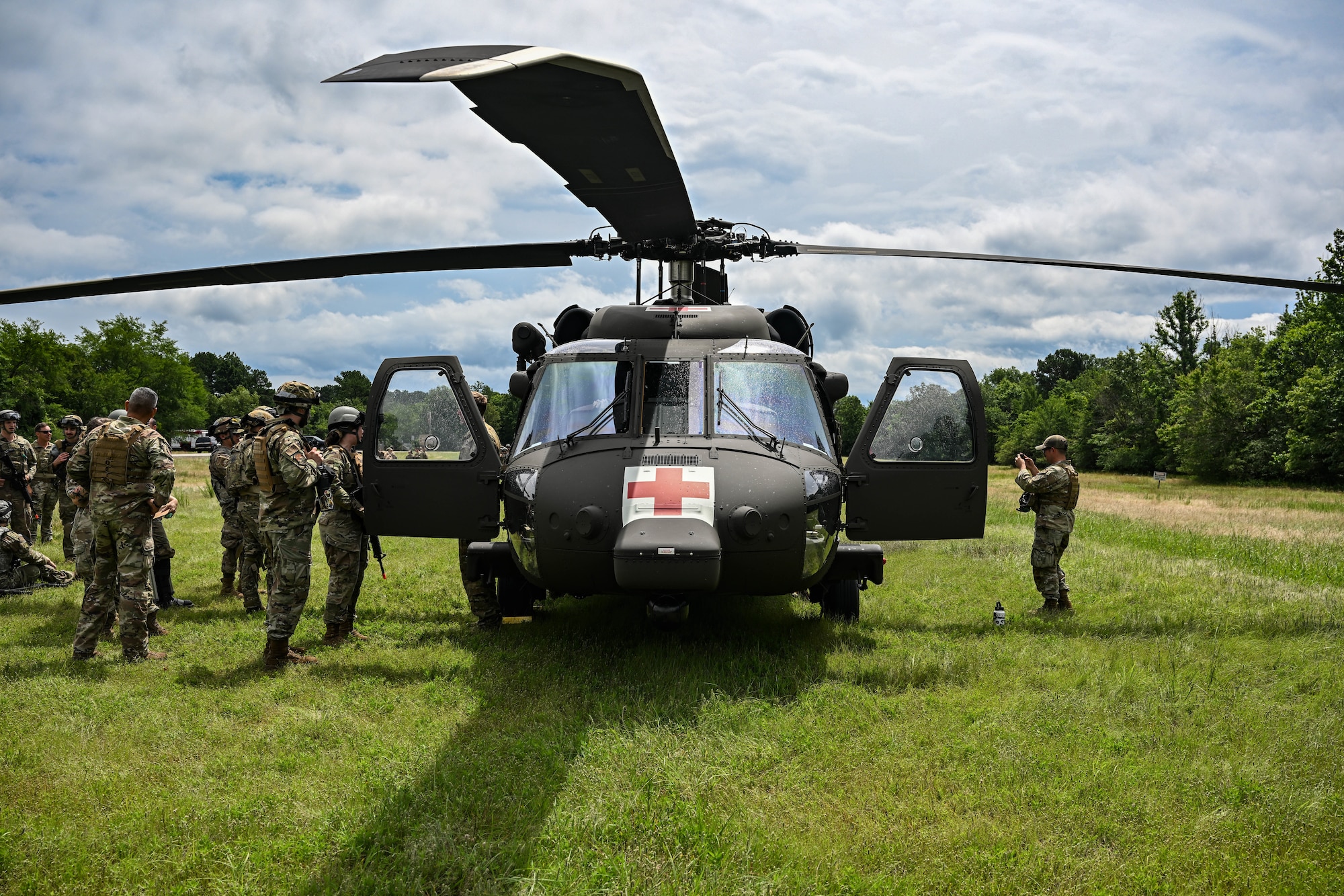 A helicopter sits in a field.