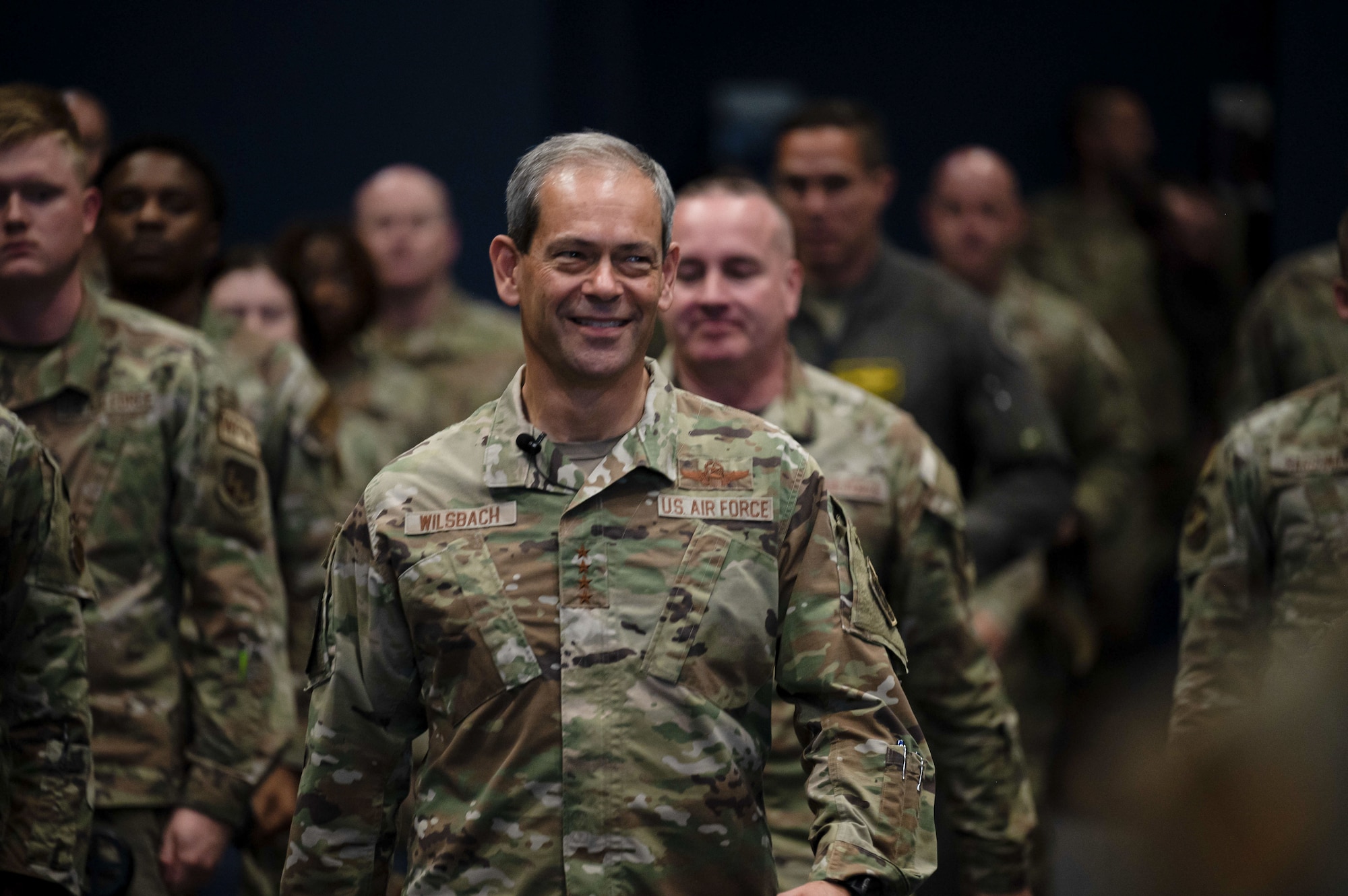 Gen. Ken Wilsbach walks down the aisle in the base theater.
