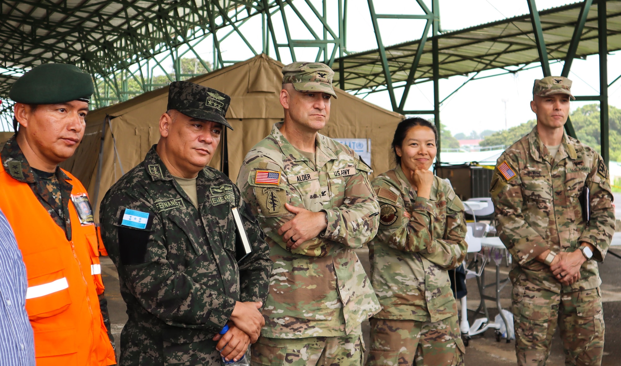 A photo of service members listening to a brief.
