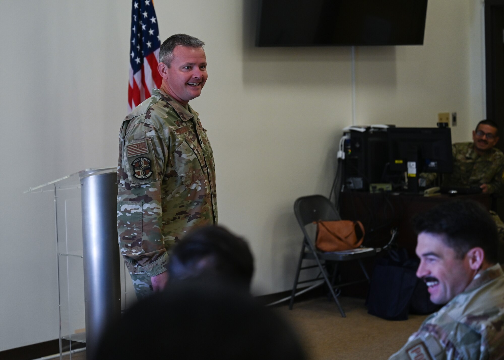 A man in uniform speaks to a crowd.