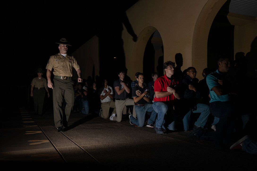U.S. Marine Corps Sgt. John Manthei, a drill instructor with Receiving Company, Support Battalion, provides instructions to the new recruits of Mike Company, 3rd Recruit Training Battalion as part of the receiving process at Marine Corps Recruit Depot San Diego, California, June 10, 2024. During the receiving process, recruits are checked for contraband, given a haircut, make a scripted phone call home, and issued their gear required for training. (U.S. Marine Corps photo by Cpl. Sarah M. Grawcock)