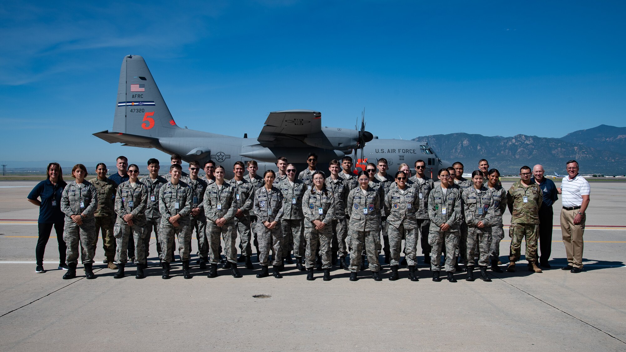 A group photo of Civil Air Patrol cadets posing in front of a C-130 aircraft.