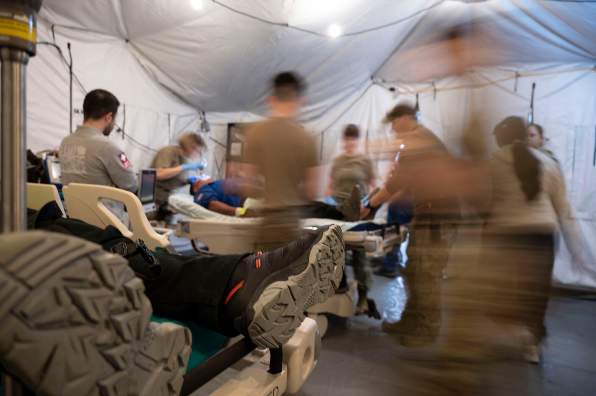 A photo of a group of people working on a simulated patient.