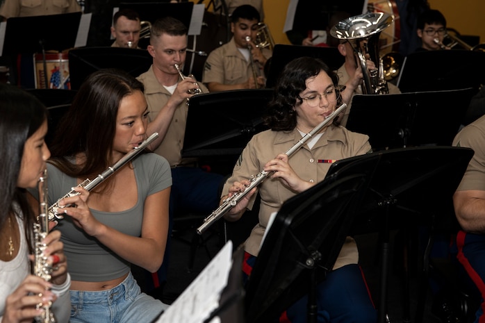 U.S. Marine Corps Cpl. Rebekah Hyde, a flute instrumentalist with the 1st Marine Division Band, right, performs with students at Long Beach Polytechnic High School, Long Beach, California, during Los Angeles Fleet Week, May 22, 2024. LAFW is an opportunity for the American public to meet their Navy, Marine Corps and Coast Guard teams and experience America’s sea services. During fleet week, service members participate in various community service events, showcase capabilities and equipment to the community, and enjoy the hospitality of Los Angeles and its surrounding areas. (U.S. Marine Corps photo by Sgt. Yvonna Guyette)