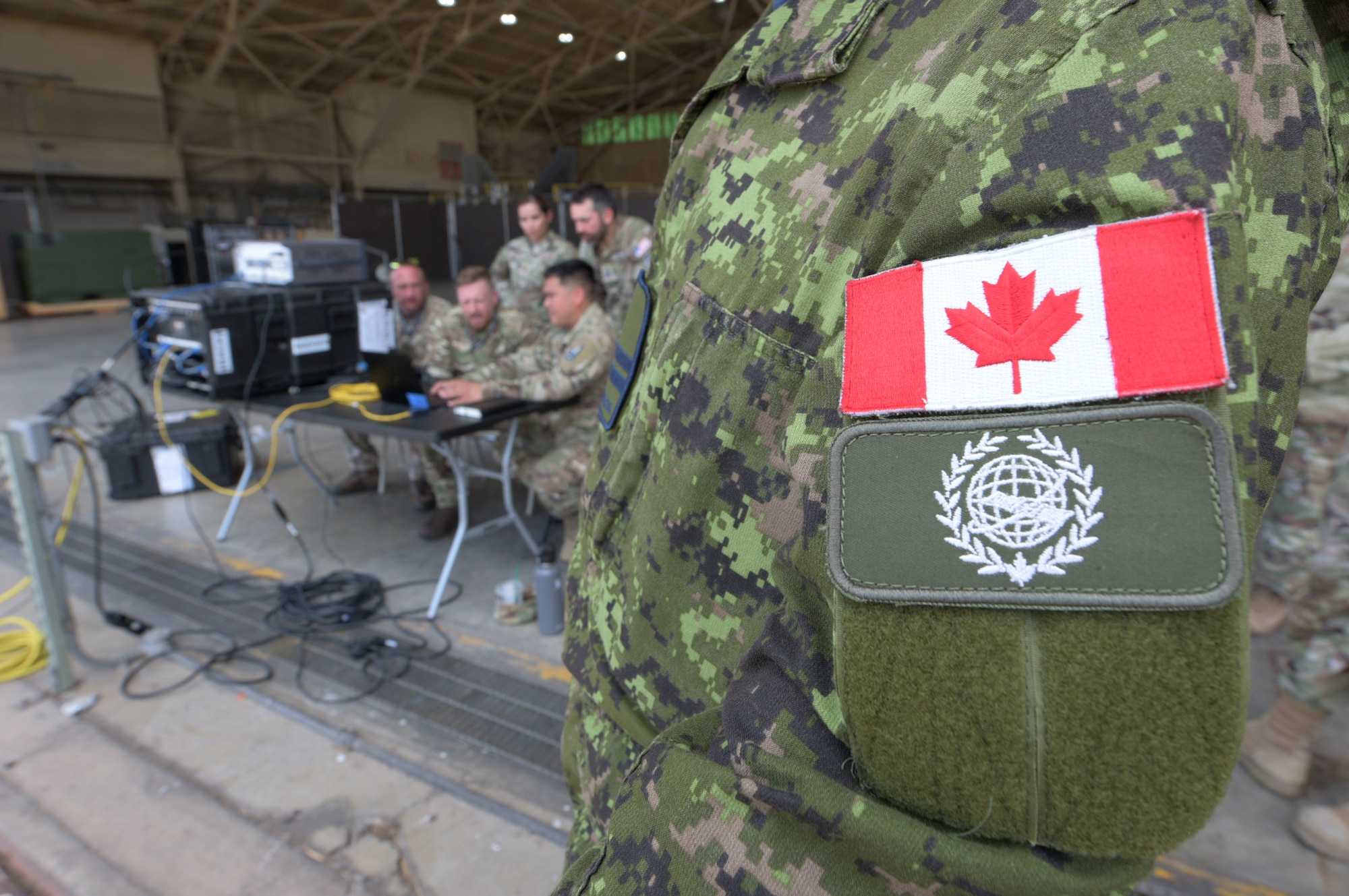A Canadian Armed Forces member of the Royal Canadian Air Force’s 3 Canadian Space Division 7 Wing (Space) joins a multinational space operations team comprised of allies, partners and five U.S. service branches in support of Valiant Shield 2024 (VS24), June 10, 2024, at Joint Base Pearl Harbor-Hickam, Hawaii. Throughout Exercise VS24, U.S. Space Command will plan, execute, and integrate military space power into multi-domain operations. Exercises such as VS24 provide Indo-Pacific Command Joint Forces an opportunity to integrate with allies and partners to conduct precise, multi-axis, multi-domain effects that demonstrate the strength and versatility of the Joint Force. (U.S. Air Force photo by Tech. Sgt. John Linzmeier)