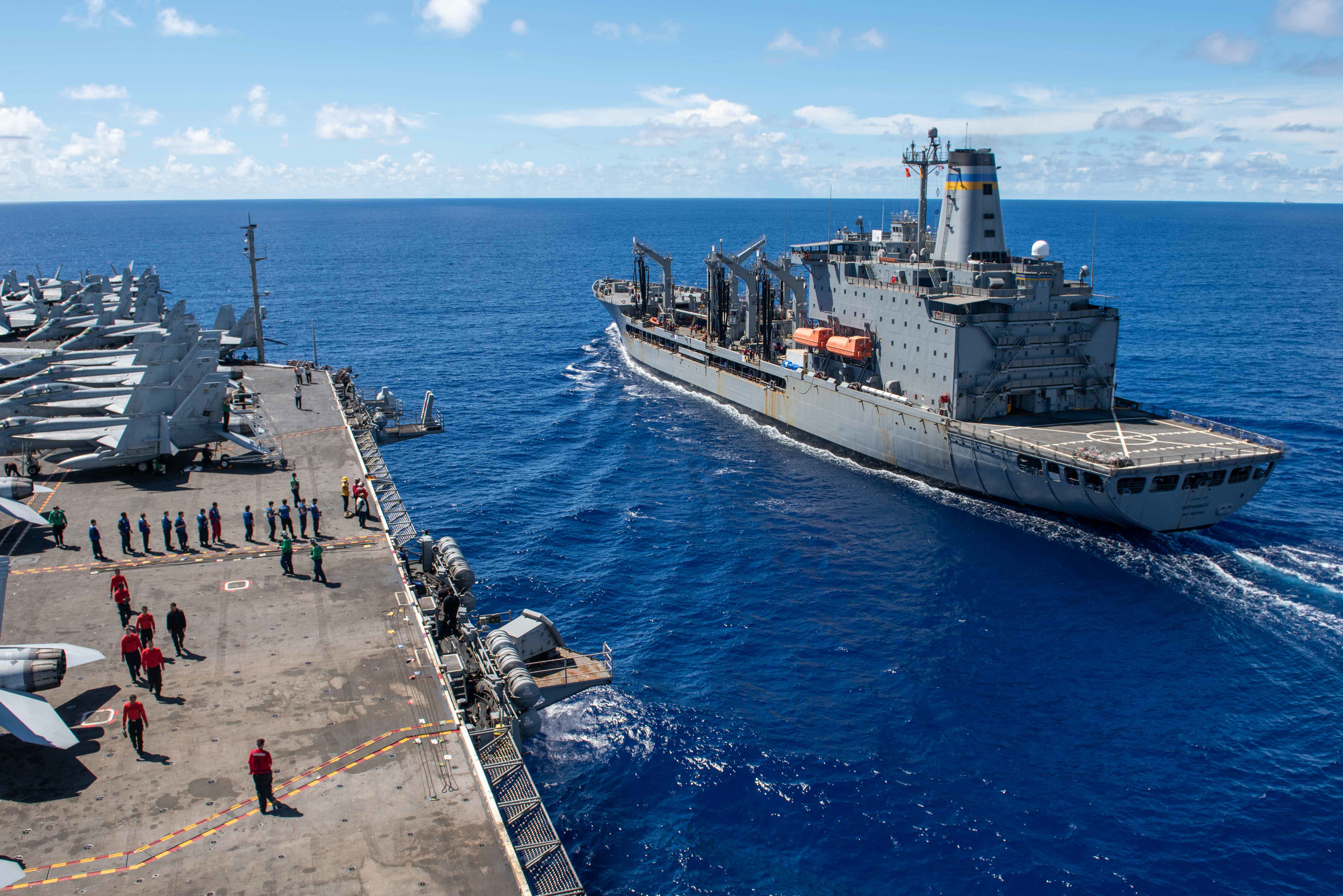 The U.S. Navy’s only forward-deployed aircraft carrier, USS Ronald Reagan (CVN 76), approaches Military Sealift Command (MSC) fleet replenishment oiler, USNS Rappahannock (T-AO 204), in preparation for a fueling-at-sea and replenishment-at sea with MSC fleet replenishment dry cargo ship, USNS Charles Drew (T-AKE-10), in the Philippine Sea, June 13.
