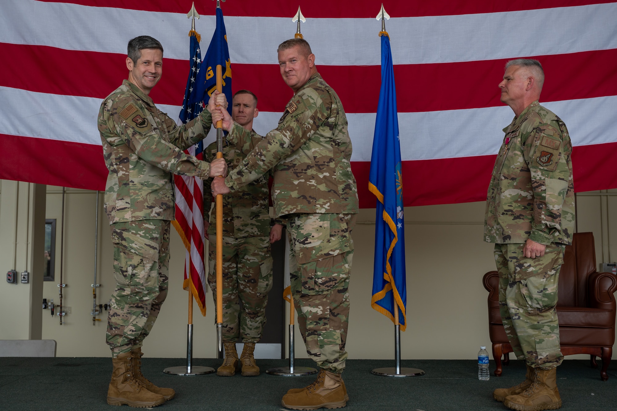 U.S. Air Force Col. Kenneth Beebe, accepts command of the 51st Maintenance Group from Col. William McKibban, 51st Fighter Wing commander, during a change of command ceremony at Osan Air Base, Republic of Korea, June 12, 2024. Prior to taking command, Beebe served as the 325th MXG deputy commander at Eglin Air Force Base, Florida. A change of command ceremony marks a smooth leadership transition, essential for preserving unit cohesion within the 51st Fighter Wing. (U.S. Air Force photo by Airman 1st Class Chase Verzaal)