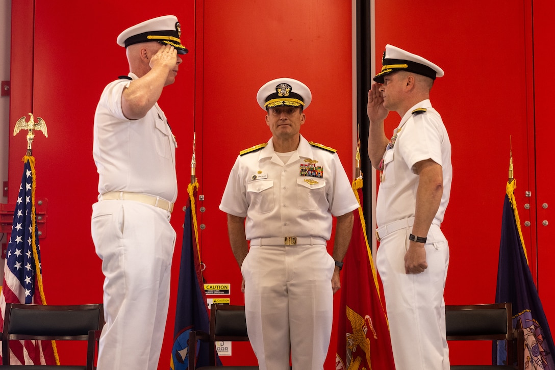 U.S. Navy Capt. Blake Burket, left, the incoming commanding officer of the Officer in Charge of Construction (OICC), and Capt. Robert Stiles, right, the outgoing commanding officer of the OICC, salute during the OICC Marine Corps Marianas change of command ceremony held at Marine Corps Base Camp Blaz, Guam, June 12, 2024. During the ceremony Stiles relinquished command to Burket. In 2016, OICC Marine Corps Marianas was established to support the Defense Policy Review Initiative in overseeing the $8.7 billion construction program, with $3.1 billion provided by the Government of Japan, to construct Marine Corps Base Camp Blaz and other facilities across Guam. (U.S. Marine Corps photo by Lance Cpl. Ryan Little)