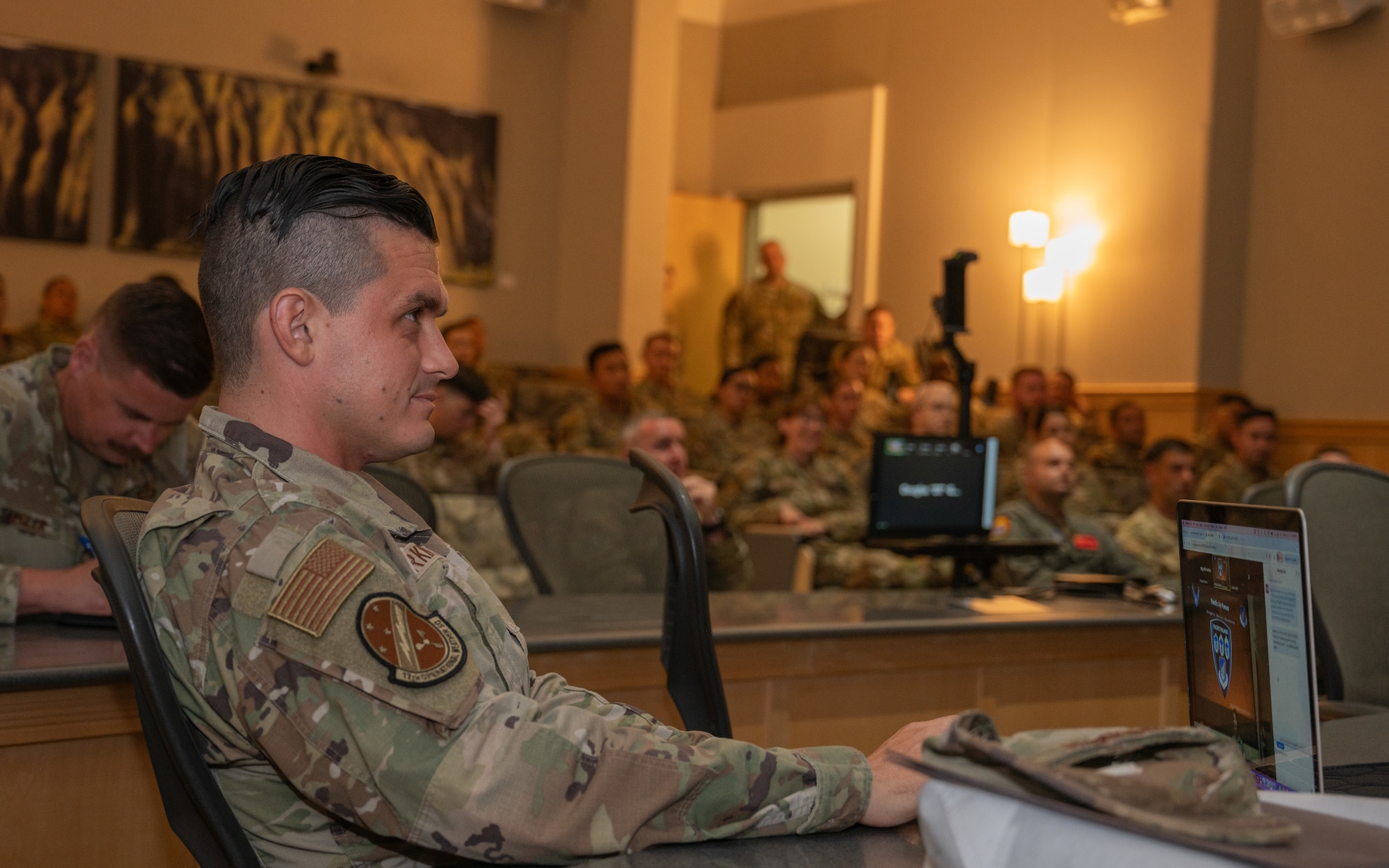 Master Sgt. William Harkins, action officer for Pacific Paladin, listens to a speaker at Joint Base Pearl Harbor-Hickam, Hawaii, on June 10, 2024. Pacific Paladin provides senior non-commissioned officers with development for effective communication and leadership.