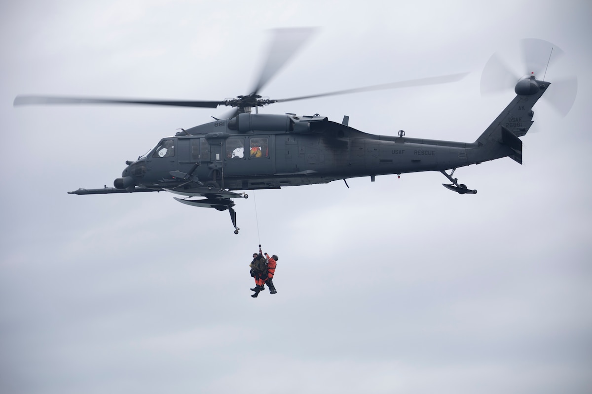 Alaska Air National Guard HH-60G Pave Hawk helicopter aviators assigned to the 210th Rescue Squadron hoist two 212th Rescue Squadron Guardian Angels during underway hoist training in the Prince William Sound near Whittier, Alaska, May 15, 2024. Guardian Angels of 212th Rescue Squadron hoisted from a 210th RQS HH-60 June 10 to rescue six plane crash victims near Port Alsworth.