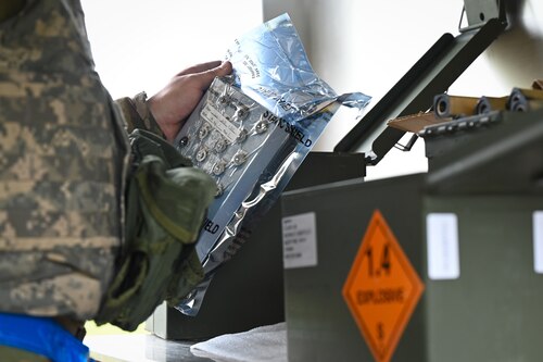 Airman prepping equipment for an M206 flare build.