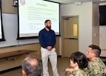JOINT BASE SAN ANTONIO-FORT SAM HOUSTON – (June 13, 2024) – Dustin Poole, a financial management analyst, assigned to Naval Medical Research Unit (NAMRU) San Antonio’s Resource Management and Acquisitions Directorate, briefed members of the command on the procedures of submitting temporary additional duty (TAD) travel via the Defense Travel System (DTS) during the ninth edition of Mission Possible, an information-sharing event, held at the Tri-Service Research Laboratory. The purpose of Mission Possible is to better inform members of the command on the tactics, techniques, and procedures of the science directorates to include the resource acquisitions and administrative directorates. NAMRU San Antonio’s mission is to conduct gap driven combat casualty care, craniofacial, and directed energy research to improve survival, operational readiness, and safety of Department of Defense (DoD) personnel engaged in routine and expeditionary operations. It is one of the leading research and development laboratories for the U.S. Navy under the DoD and is one of eight subordinate research commands in the global network of laboratories operating under the Naval Medical Research Command in Silver Spring, Md. (U.S. Navy photo by Burrell Parmer, NAMRU San Antonio Public Affairs/Released
