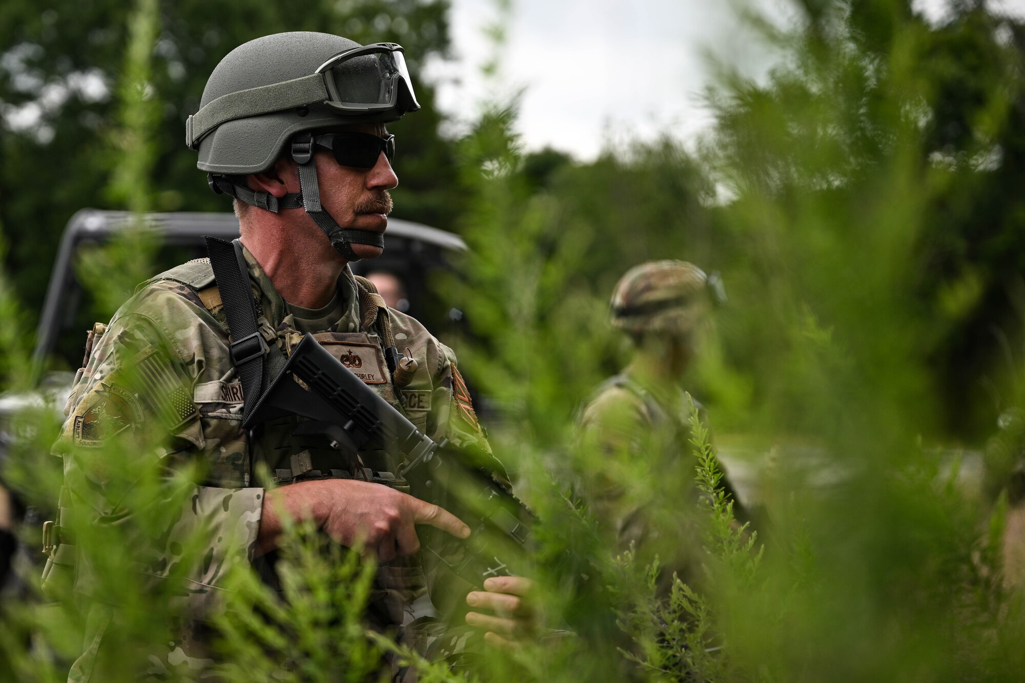 A man in uniform hold a weapon.