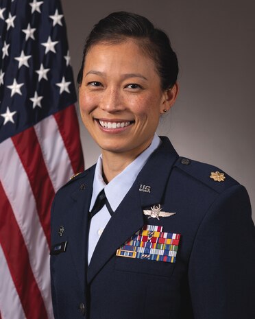 photo of uniformed U.S. Air Force Airmen standing in front of U.S. flag