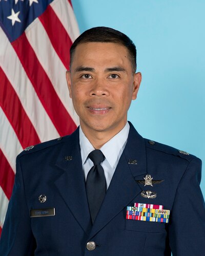 photo of uniformed U.S. Air Force Airmen standing in front of U.S. flag