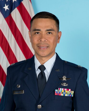 photo of uniformed U.S. Air Force Airmen standing in front of U.S. flag