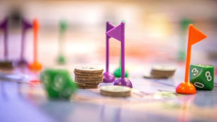 Plastic flags, dice, and other board game pieces sit on a map  during a Lead Wing Command and Control Course.