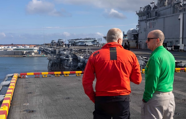 SKAGEN, Denmark (June 12, 2024) Morten Weesgaard, a Danish harbor pilot, left, and Cmdr. Keith Brooks, a chaplain assigned to the amphibious assault ship USS Wasp (LHD 1), stand on the flight deck as the ship moors to the pier in Skagen, Denmark, June 12, 2024. Wasp is conducting operations in the U.S. Naval Forces Europe area of operations as the flagship of the Wasp Amphibious Ready Group (WSP ARG)-24th Marine Expeditionary Unit (MEU) Special Operations Capable (SOC). The WSP ARG-24th MEU (SOC) support high-end warfighting exercises while demonstrating speed and agility operating in a dynamic security environment. (U.S. Navy photo by Mass Communication Specialist 2nd Class Eric A. Moser)