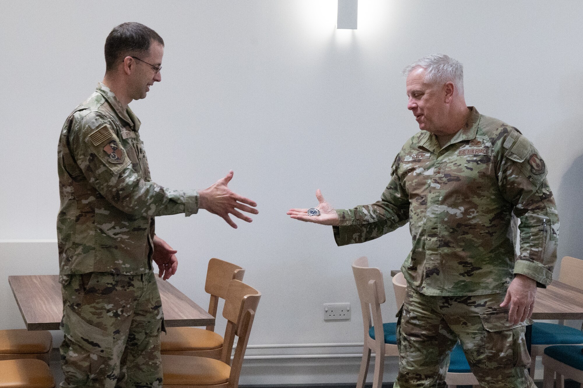 U.S. Air Force Maj. Gen. John J. Allen Jr., Air Force Installation and Mission Support Center commander, right, coins Lt. Col. Joshua D. Rumsey, 501st Combat Support Wing chaplain on RAF Fairford.