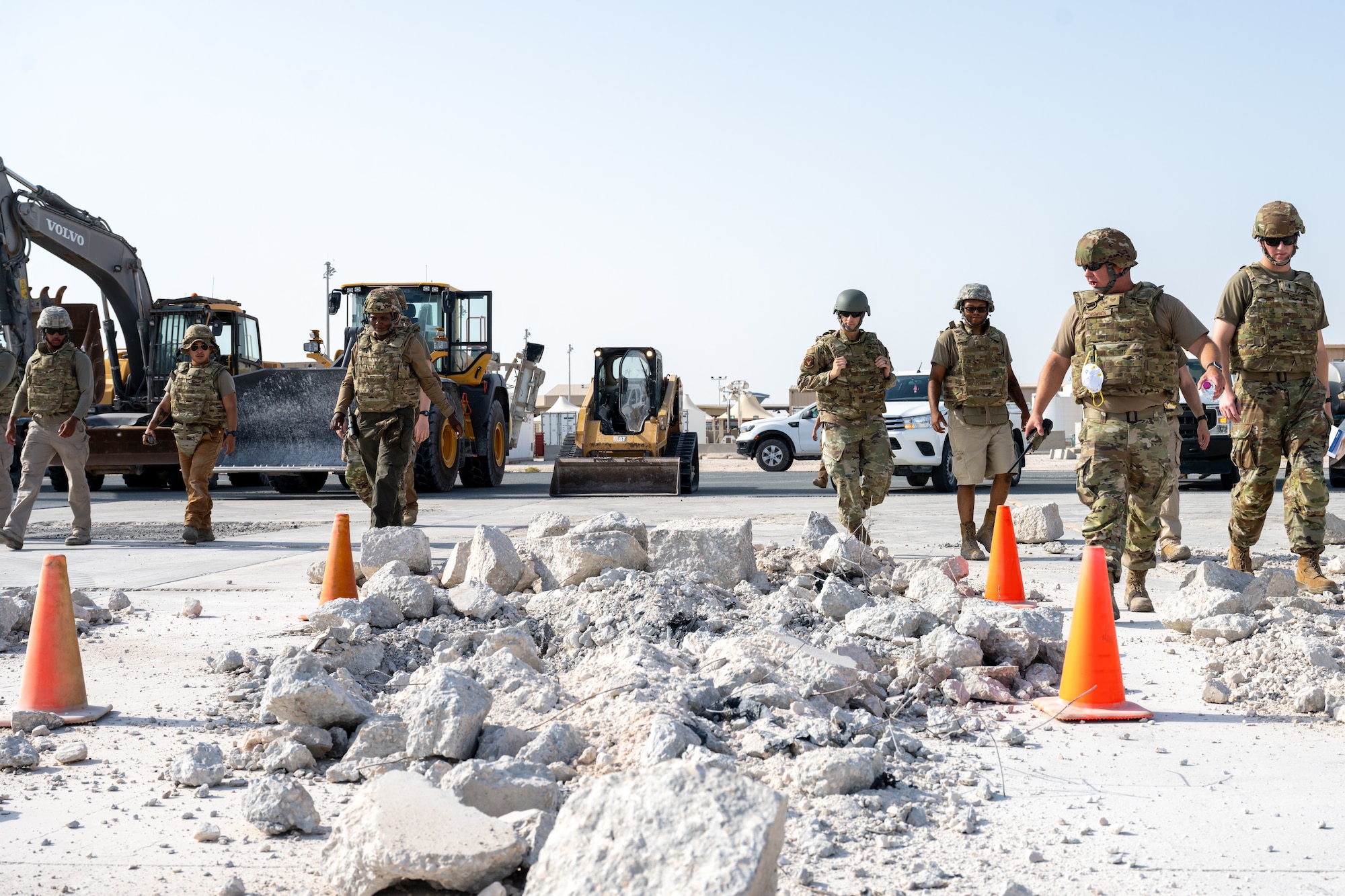 Airmen assigned to the 379th Expeditionary Civil Engineer Squadron perform a site survey on a simulated damaged airfield during a Rapid Airfield Damage Repair exercise at an undisclosed location within the U.S. Central Command area of responsibility, June 12, 2024.