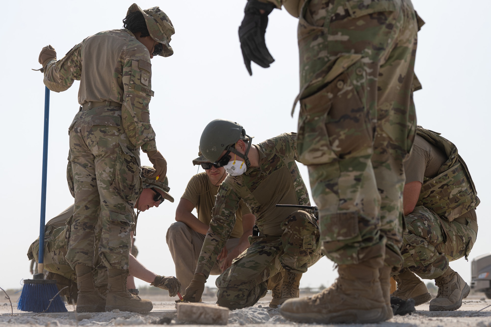 Airmen assigned to the 379th Expeditionary Civil Engineer Squadron use a measuring tool during a Rapid Airfield Damage Repair exercise at an undisclosed location within the U.S. Central Command area of responsibility, June 12, 2024.