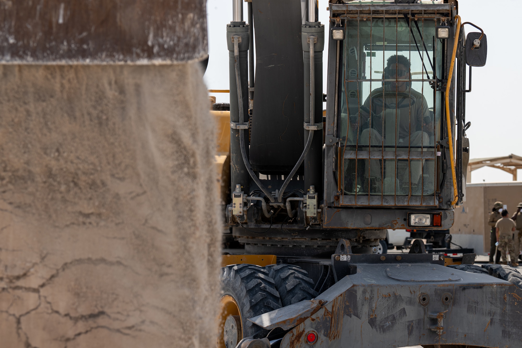 A pavement and construction equipment specialist assigned to the 379th Expeditionary Civil Engineer Squadron operates an excavator during a Rapid Airfield Damage Repair exercise at an undisclosed location within the U.S. Central Command area of responsibility, June 12, 2024.