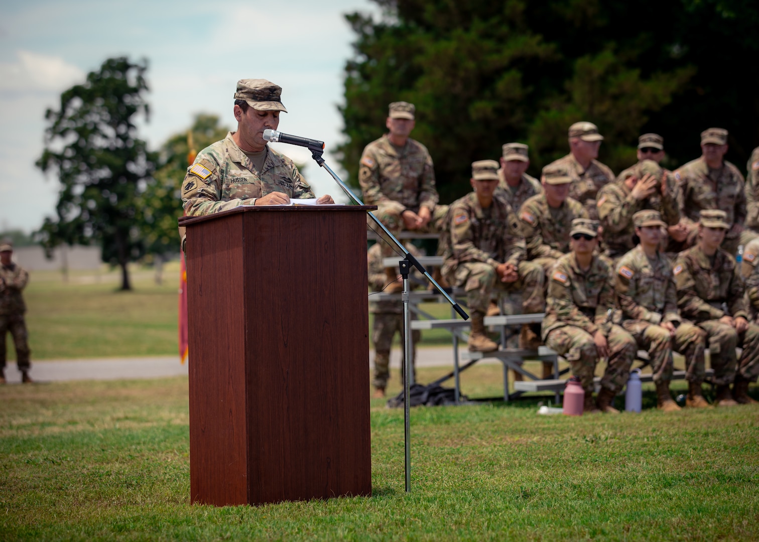 Col. Khalid Hussein, incoming commander of the 45th Infantry Brigade Combat Team, speaks during a change of command ceremony held at Camp Gruber Training Center near Braggs, Oklahoma, June 11, 2024. Hussein brings extensive experience to his new role, having served in numerous command and staff positions within the IBCT. Outgoing commander, Col. Andrew Ballenger, served in the position since 2022. (Oklahoma National Guard photo by Cpl. Danielle Rayon)